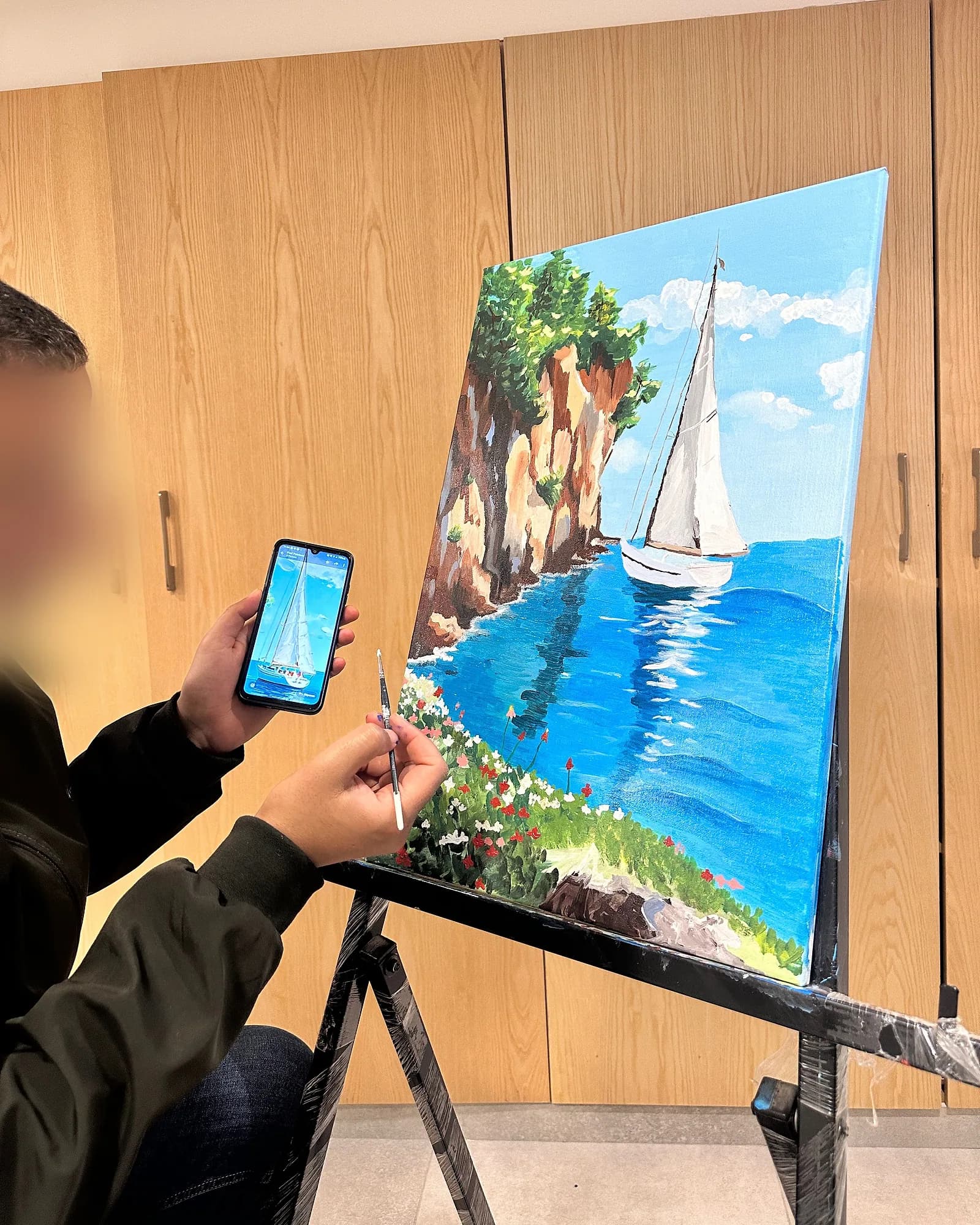 Photographing a finished painting to share in an online art class – online arts plastiques class